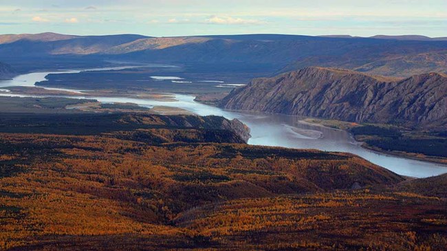 An aerial image of the Yukon River showing the rocky cliffs and uplands.
