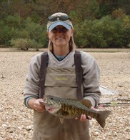 Hope Dodd holding a fish during field work