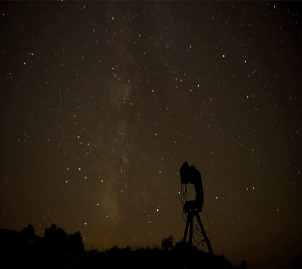 Timelapse of a camera turning on a large, automated mount as the stars move across the sky