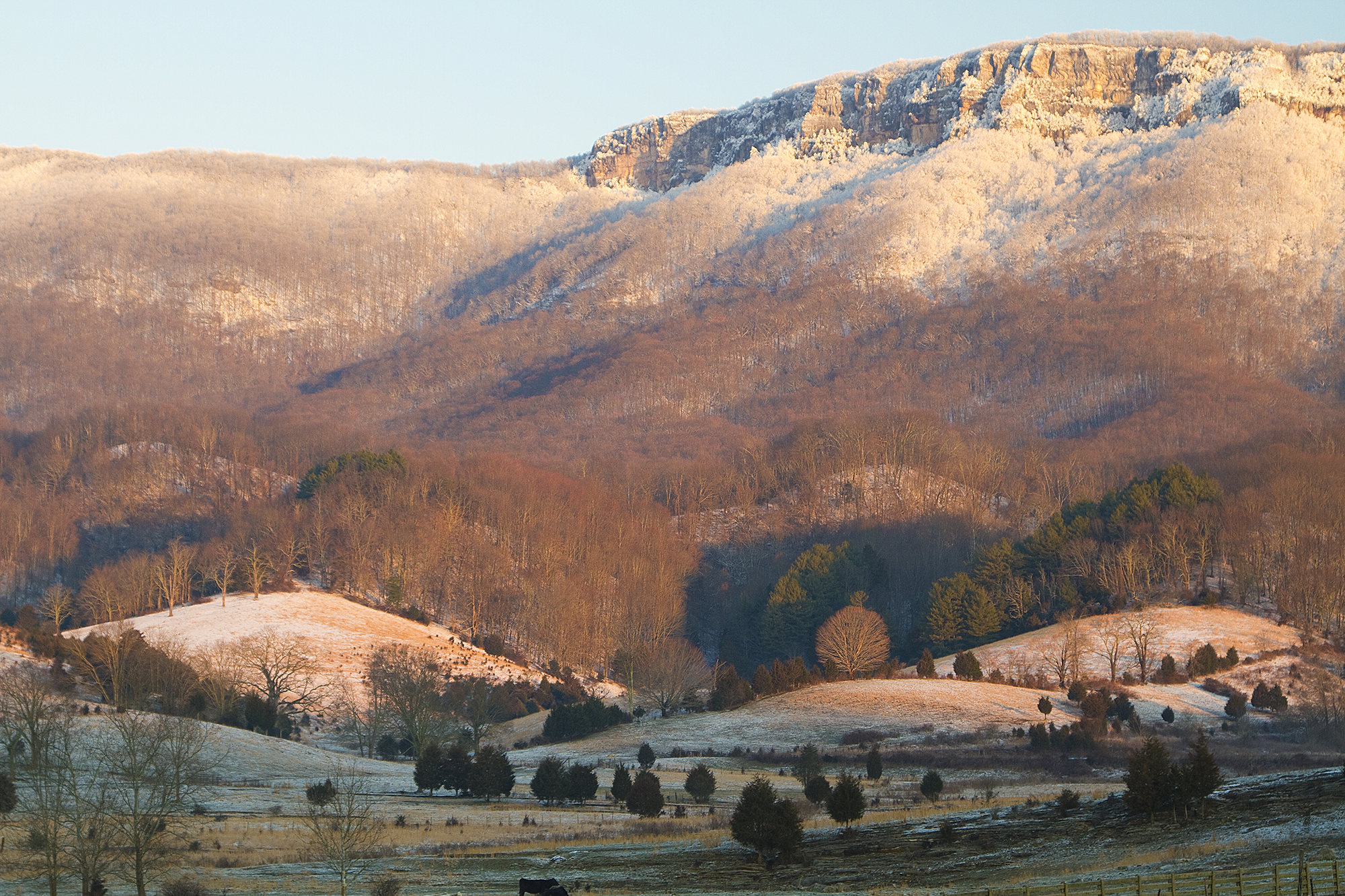 White Cliffs tower over a valley floor in snow. White Cliffs tower over a valley floor in snow.