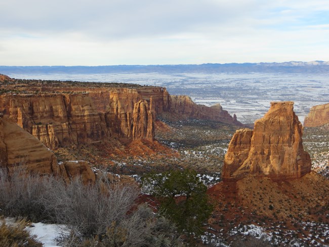 Red rock canyons with open, flat landscape beyond