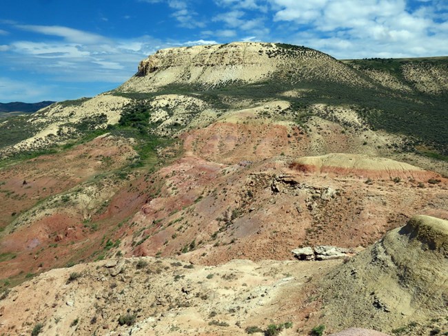 Layered ridge with white Fossil Butte Member above red Wasatch Formation slopes