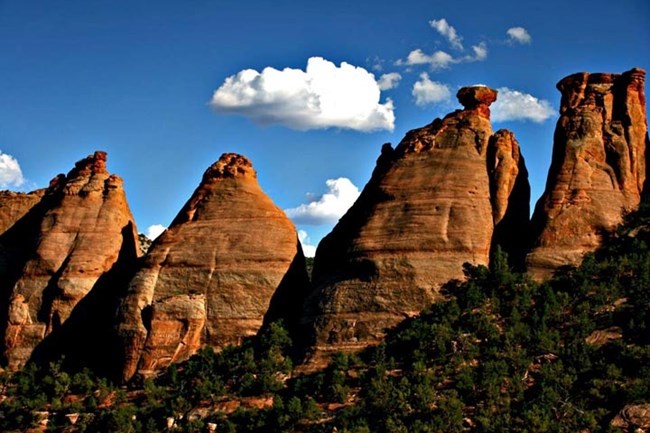 Coke Ovens rock formations in Colorado National Monument under blue sky