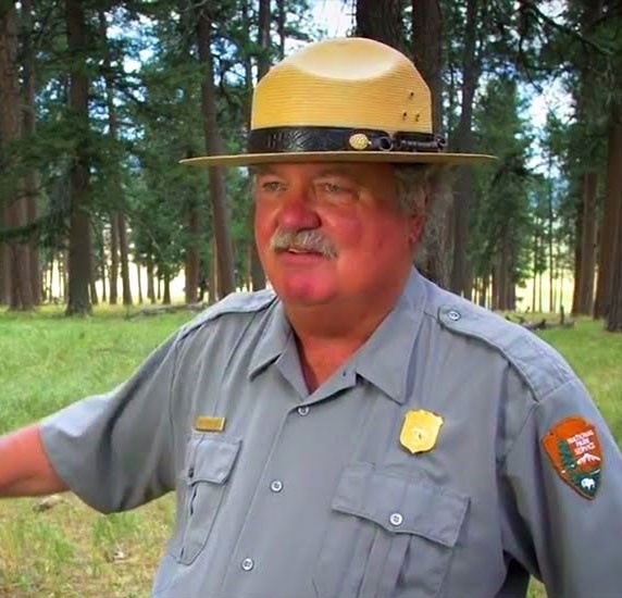 Man in a ranger hat and gray ranger uniform.