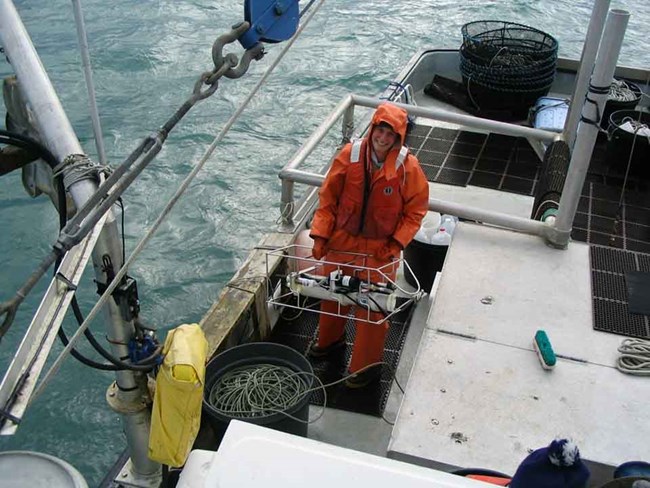 A researcher prepares instruments to collect ocean water chemistry.