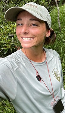 Woman wearing a hat smiling for camera