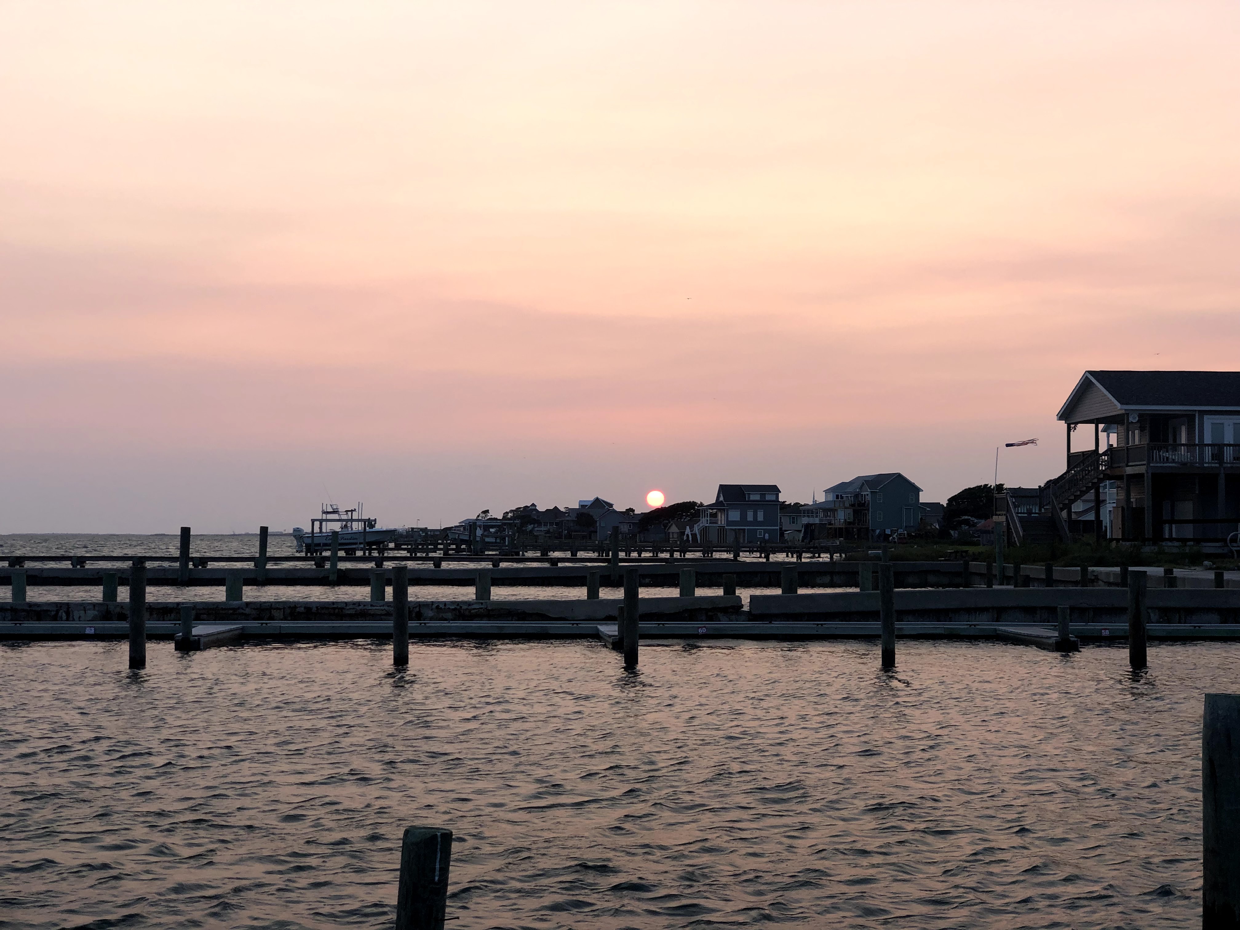 String of docks down a waterway at sunset