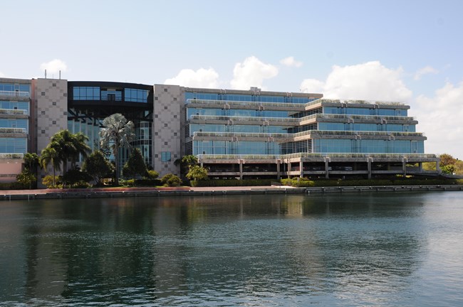 The South Florida/Caribbean Network main office building next to a lake