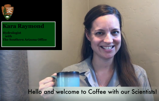 Smiling woman in NPS uniform holds coffee cup