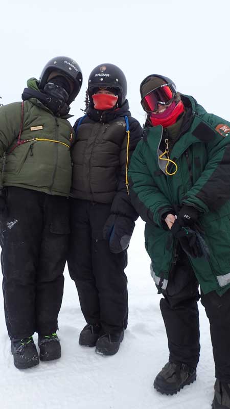 three park rangers in winter gear
