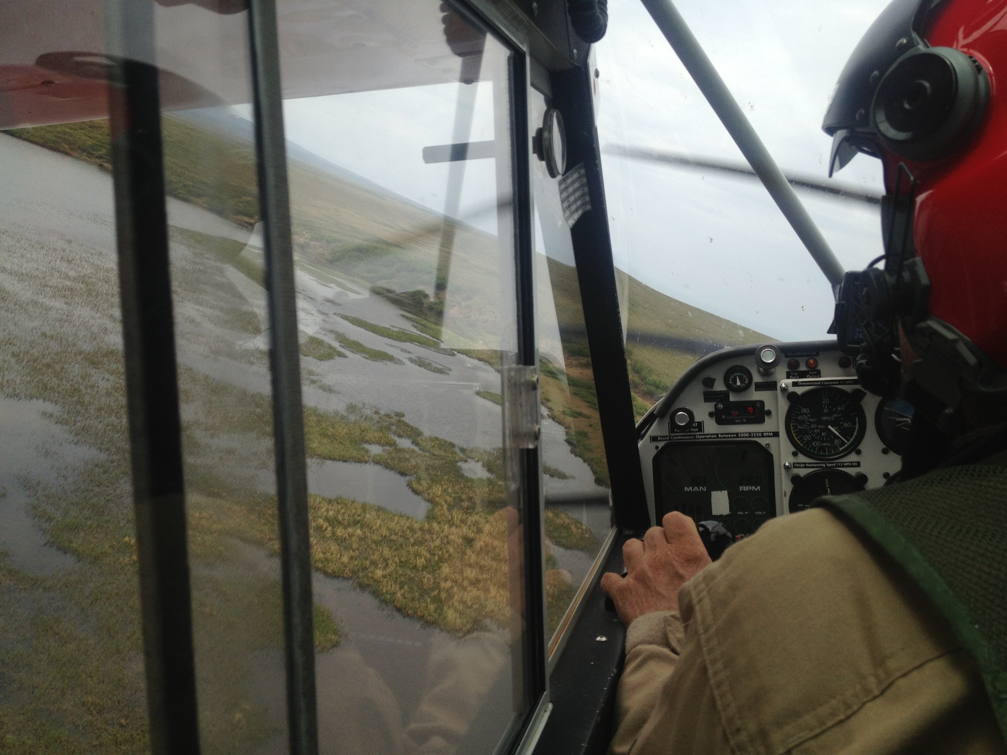 A view from the cockpit of a small plane as the pilot swerves his aircraft in search of loons nesting in marshes in Bering Land Bridge National Preserve.