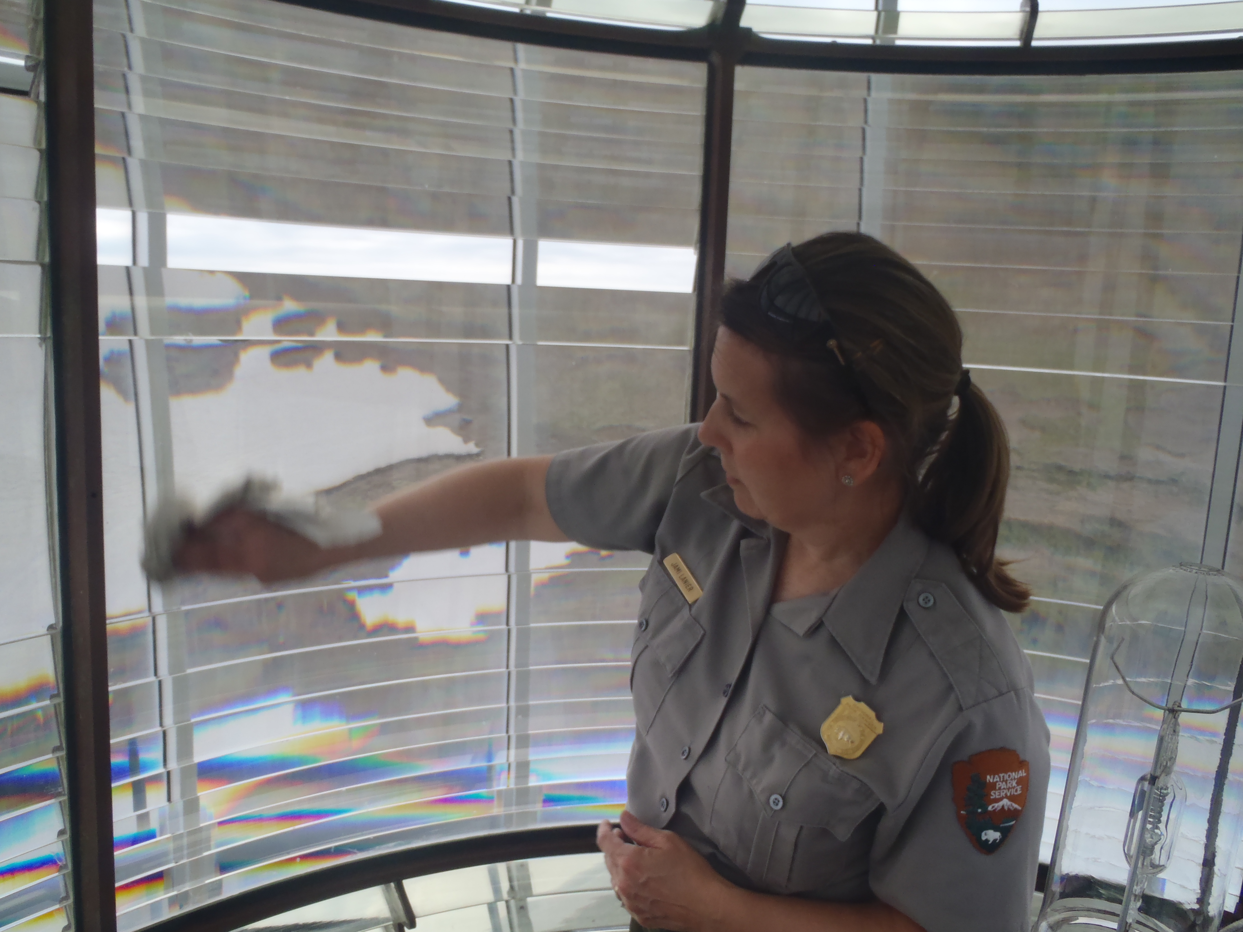 Jami Lanier cleaning Bodie Island Fresnel lens