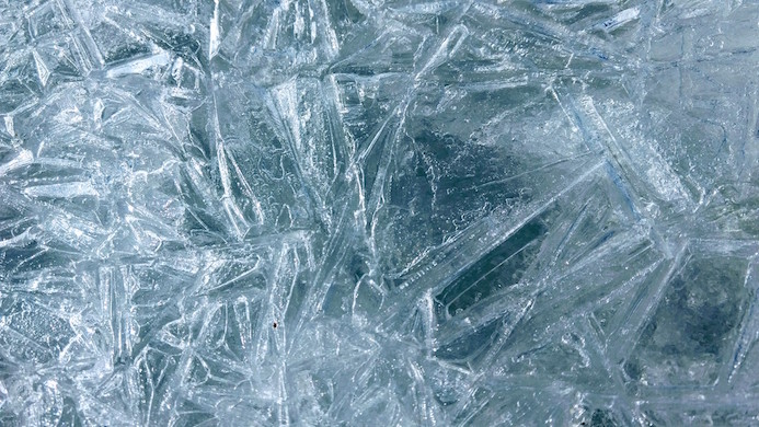 A close-up view of an ice sheet shows its linear structures