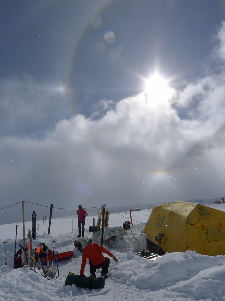 A giant sundog-rainbow hovers over 14 camp