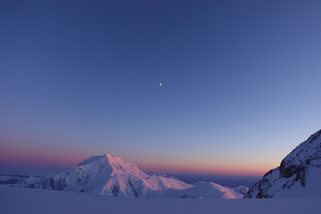 The sun sets and moon rises over Mount Foraker
