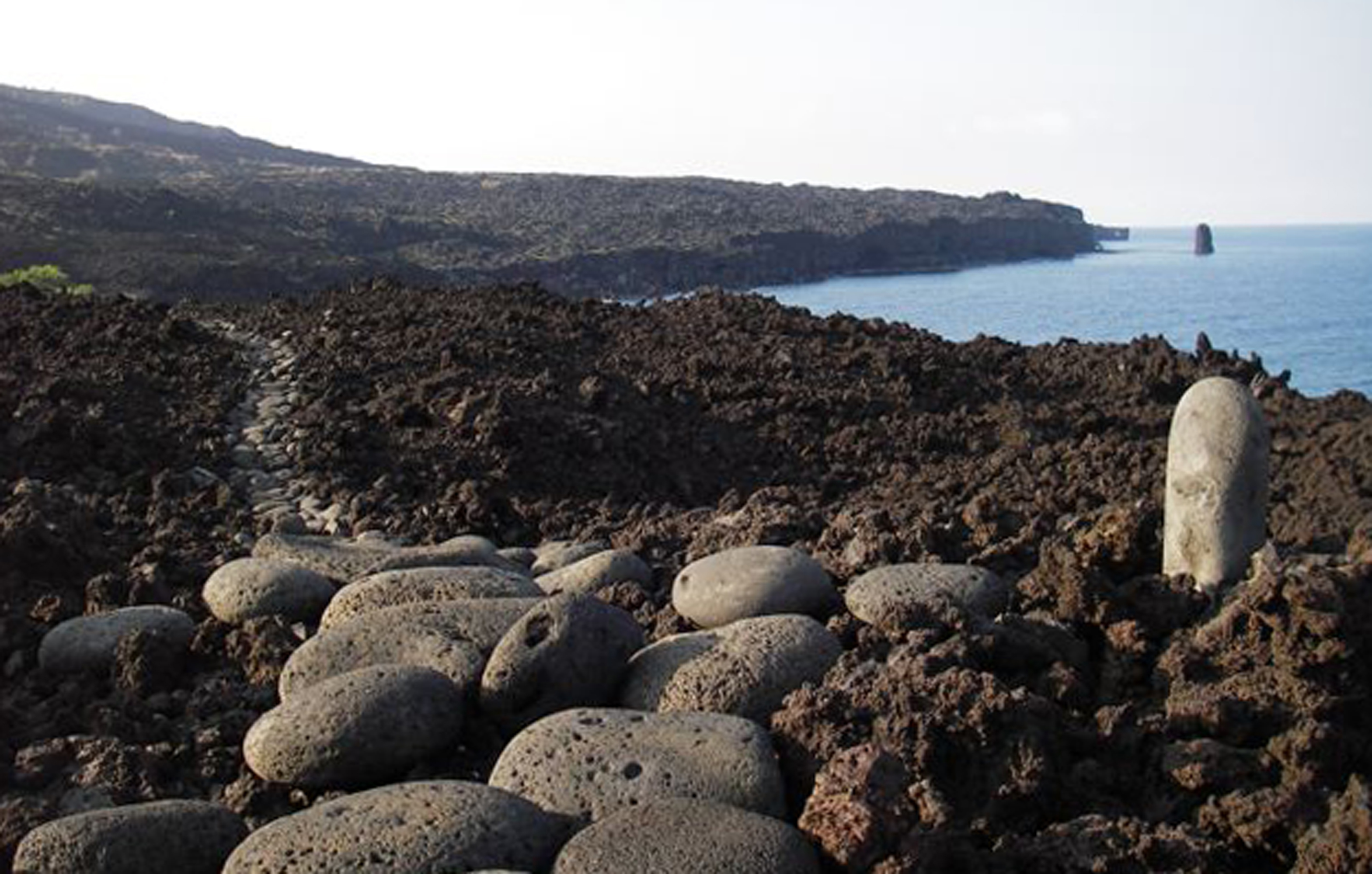 A waterworn stepping stone trail through a'a lava and next to the sea