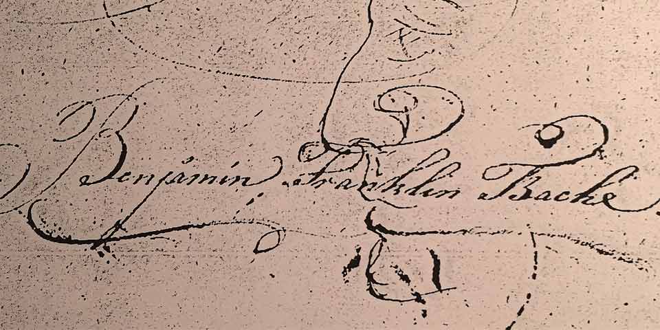 Image of the signature of Benjamin Franklin Bache, written in black ink on a tan background.