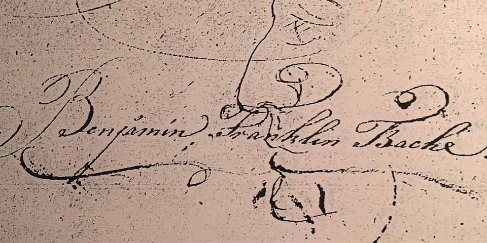 Image of the signature of Benjamin Franklin Bache, written in black ink on a tan background.
