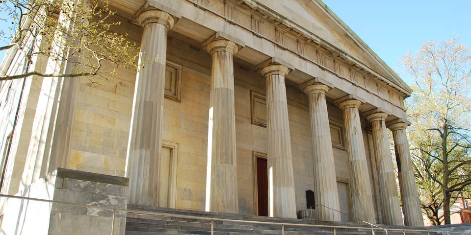 Exterior view of the north facade of the Second Bank of the United States showing eight marble columns topped with a triangular pediment.