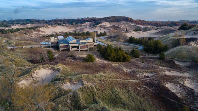 Aerial photograph of West Beach Bath House, a cement, one-storied, modular structure with clerestories on the roof.