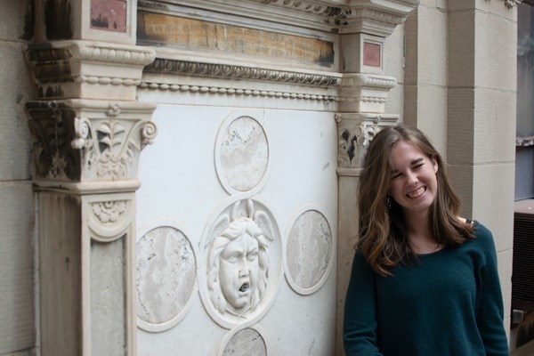 image of artist standing in front of marble fountain