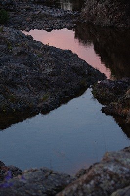 a splash pool in the vicinity of Scoville Point at dusk with basalt surrounding