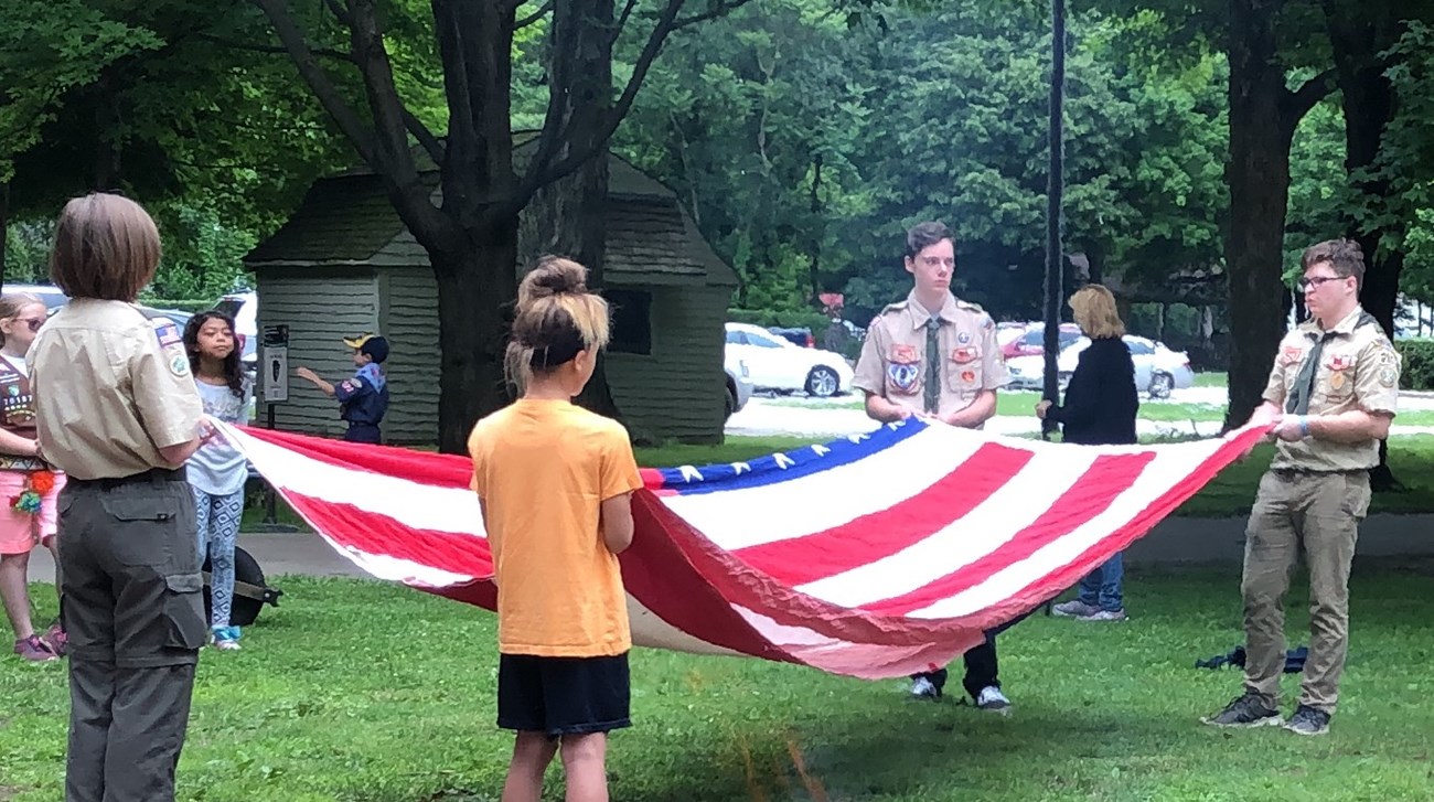 Scouts folding an American flag