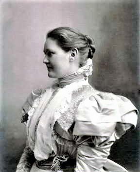 a portrait of a young Helen Garfield wearing a dress