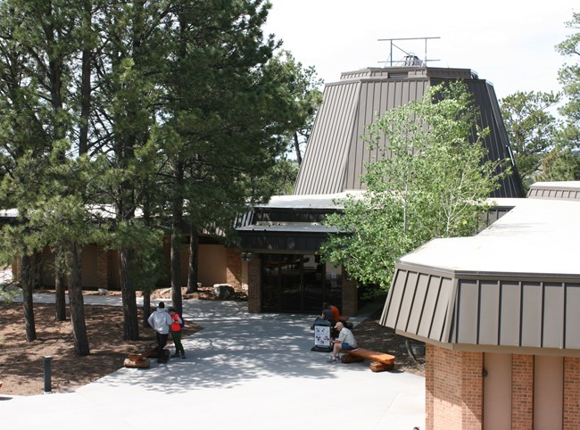 A large brick building with a paved patio in front