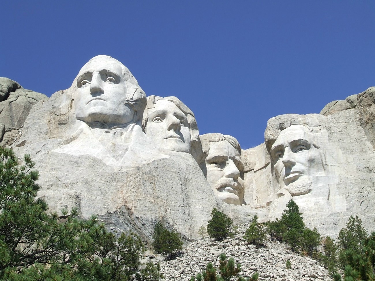 Mount Rushmore with blue skies in background.