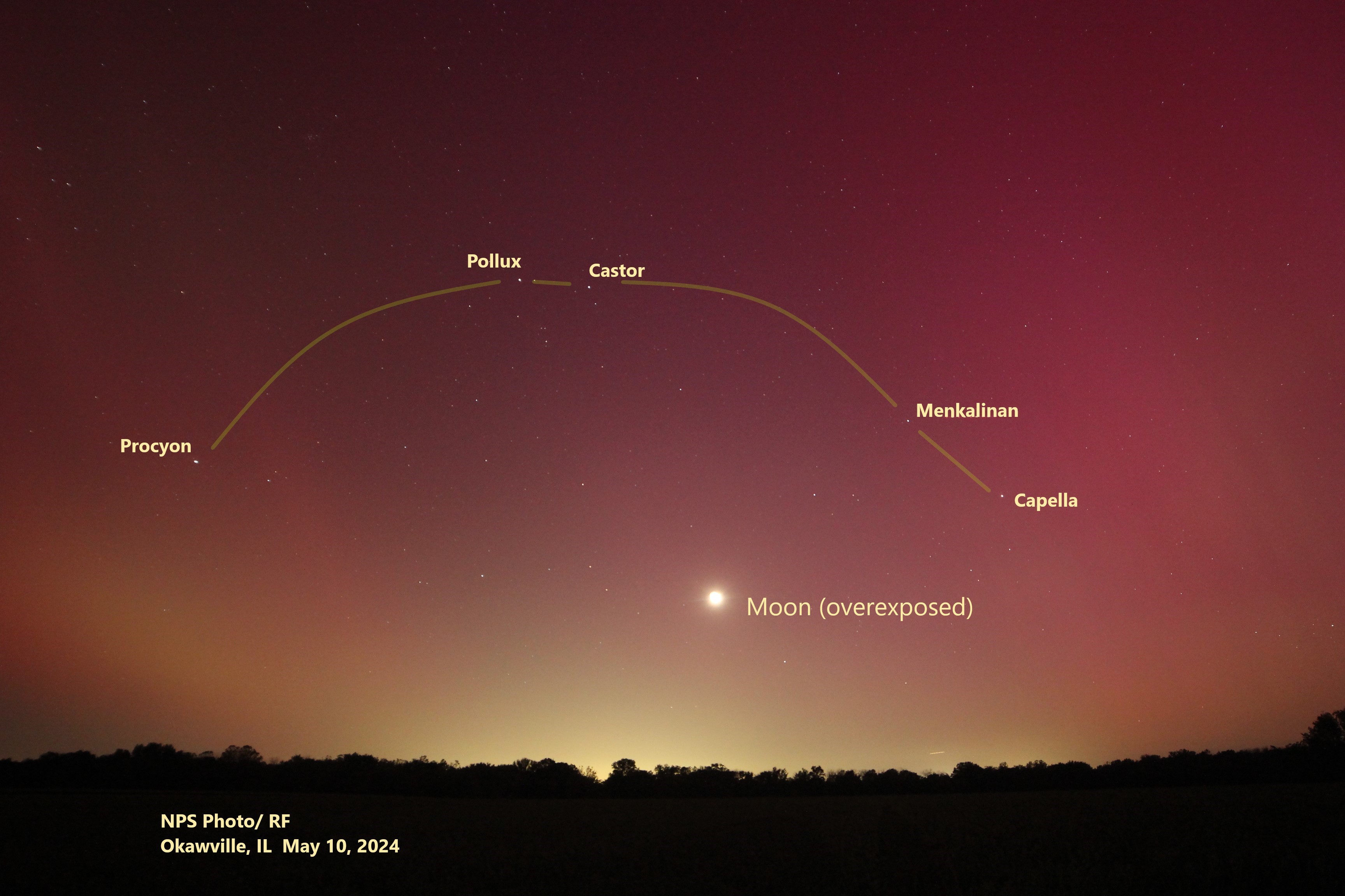 aurora arch of spring The pink glow of the aurora, above the tree line of the horizon.
