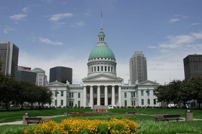 The Old Courthouse with yellow flowers blooming in front.