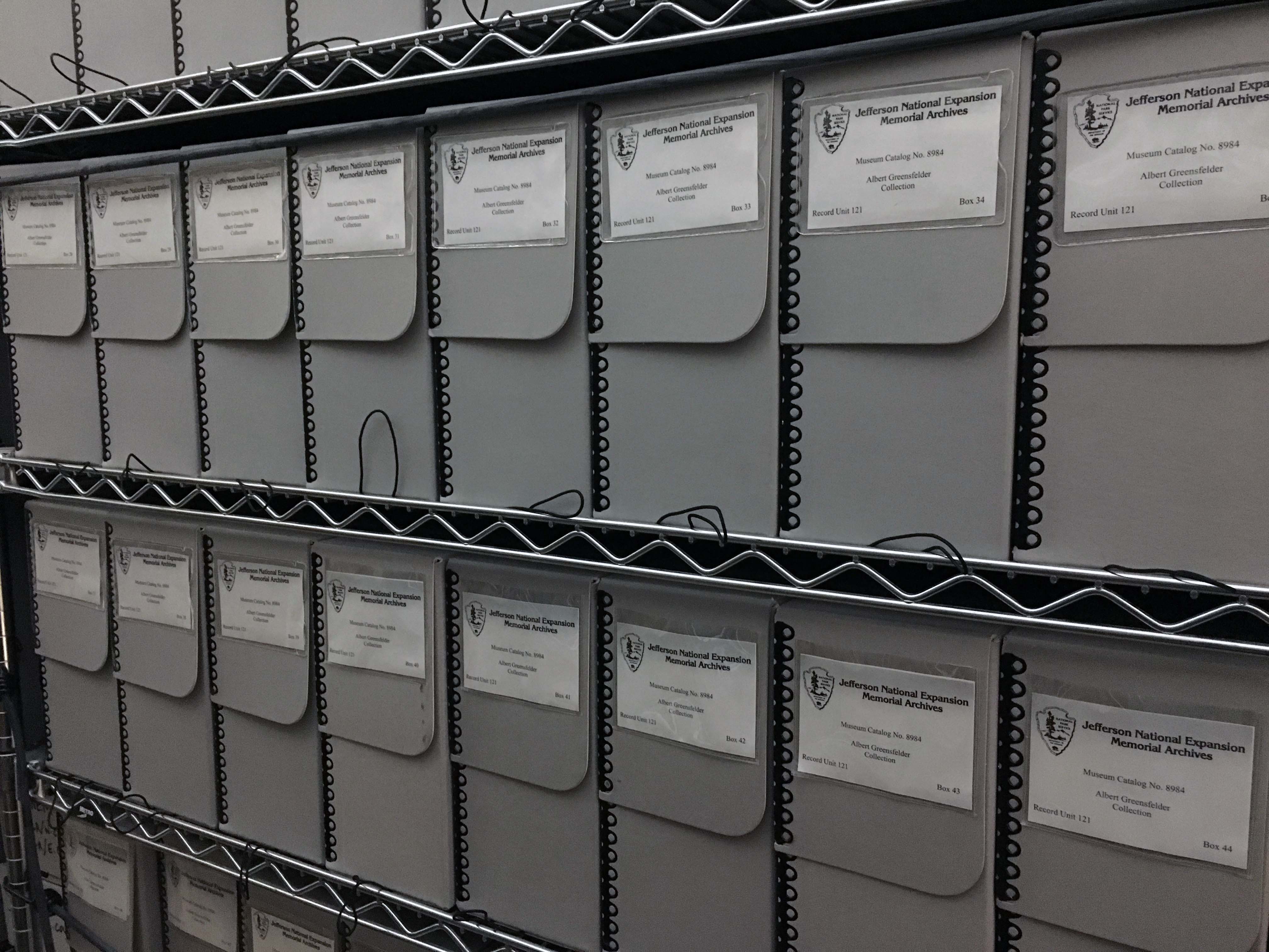 Gray archival boxes on shelves.