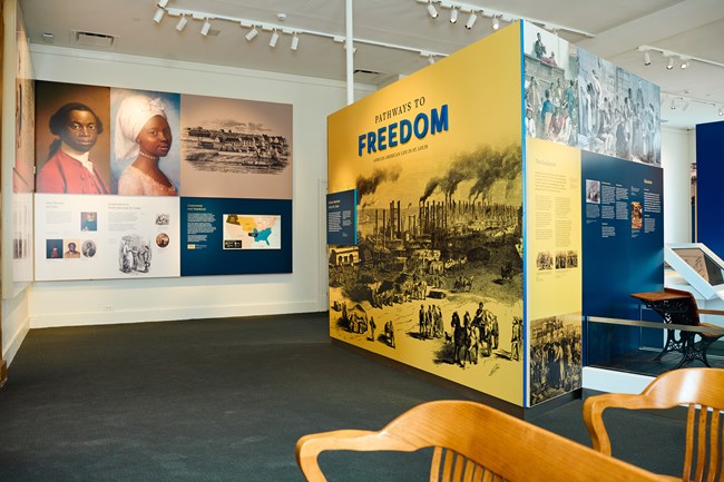 Museum exhibits of historical African American people, a map, and a bustling riverfront