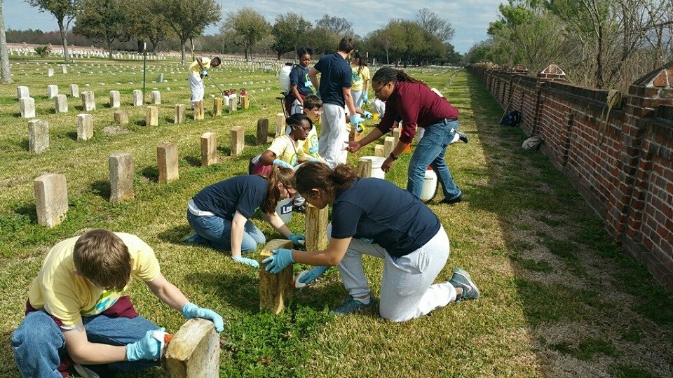 Volunteers clean national cemetery headstones