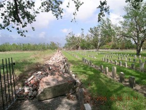 Brick wall at Chalmette National Cemetery lies in ruins after Hurricane Katrina in 2005.