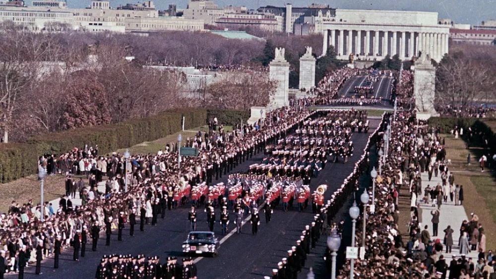 Parade units crossing a bridge with Lincoln Memorial in background