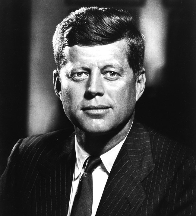 JFK in a suit facing the camera