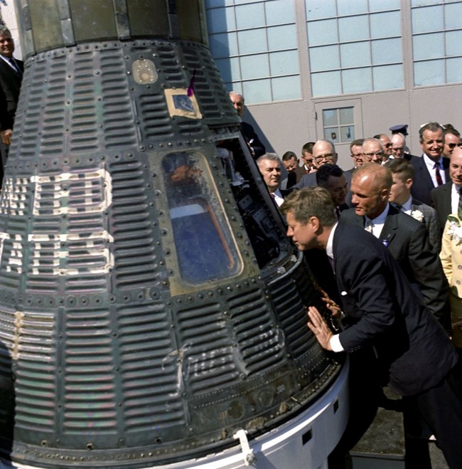 JFK observes a space capsule