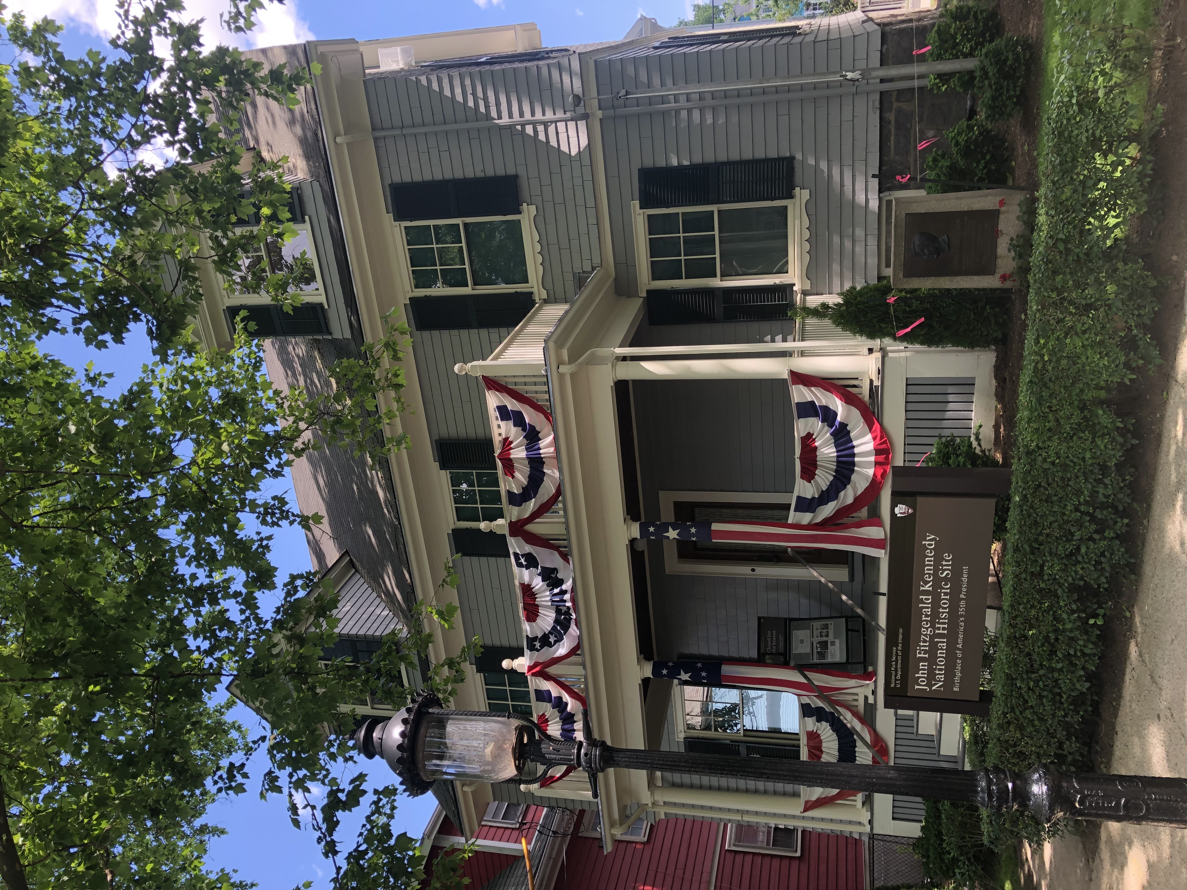 Photo of 83 Beals Street, the birthplace of JFK, newly renovated and with patriotic bunting out front.