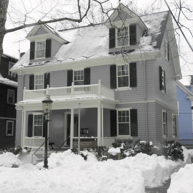 A photo of the JFK birthplace covered in snow.