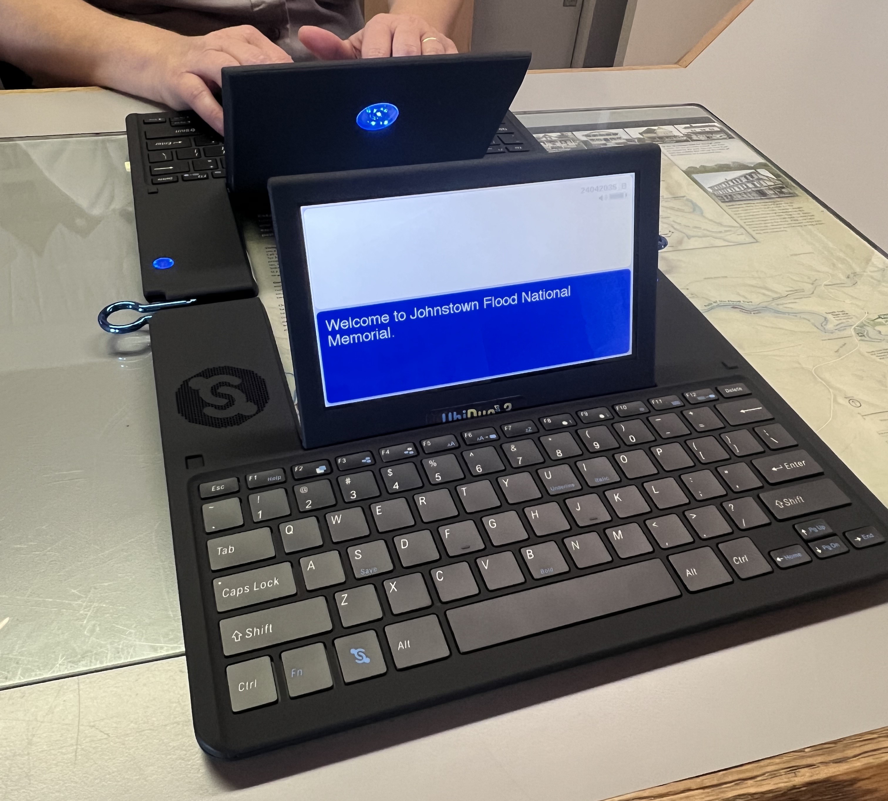 A park ranger types Welcome to Johnstown Flood National Memorial in the Ubi-Duo