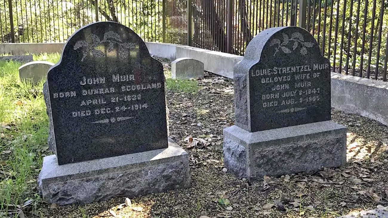 Gravestones of John Muir (1838–1914) and Louie Strentzel Muir (1841–1905) in a shaded cemetery.