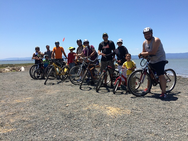 Group of bike riders on a trail by the Bay.