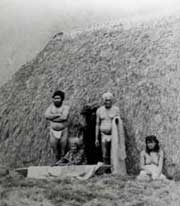 Hawaiian residents at their grass hut in Kalaupapa.