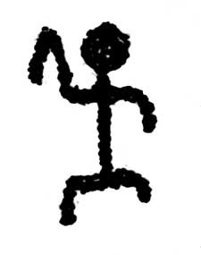 A black carving that looks like a human with a head, body, legs, and arms.
