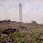 A tall white building on a ridge.