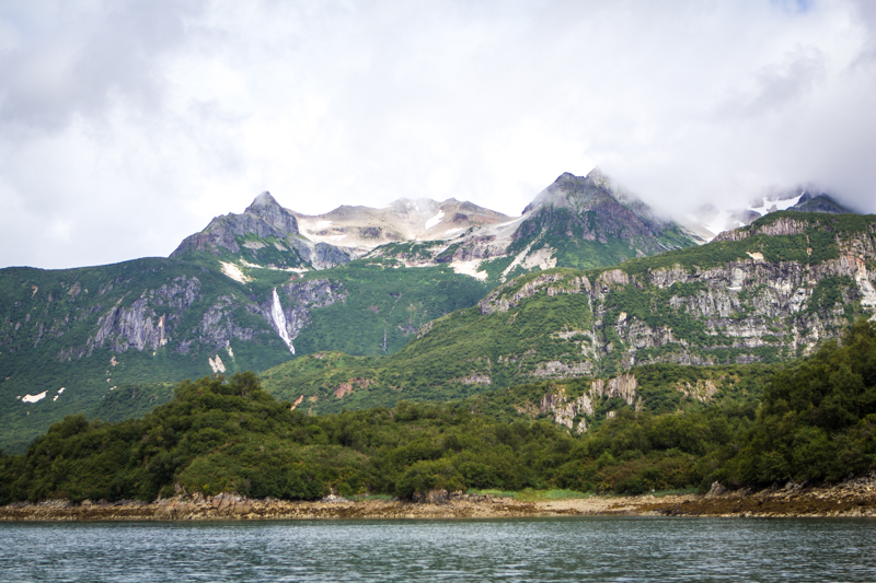 Mountain peaks and a waterfall overlook Amalik Bay