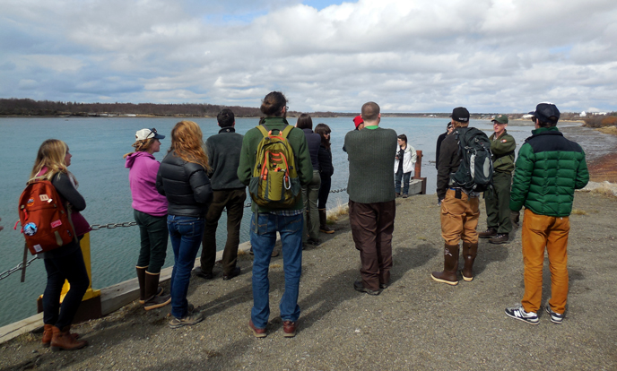 Staff discuss salmon migration in Naknek River