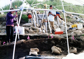 Archeologists use a laser transit to get extremely accurate measurements of artifacts and house features.